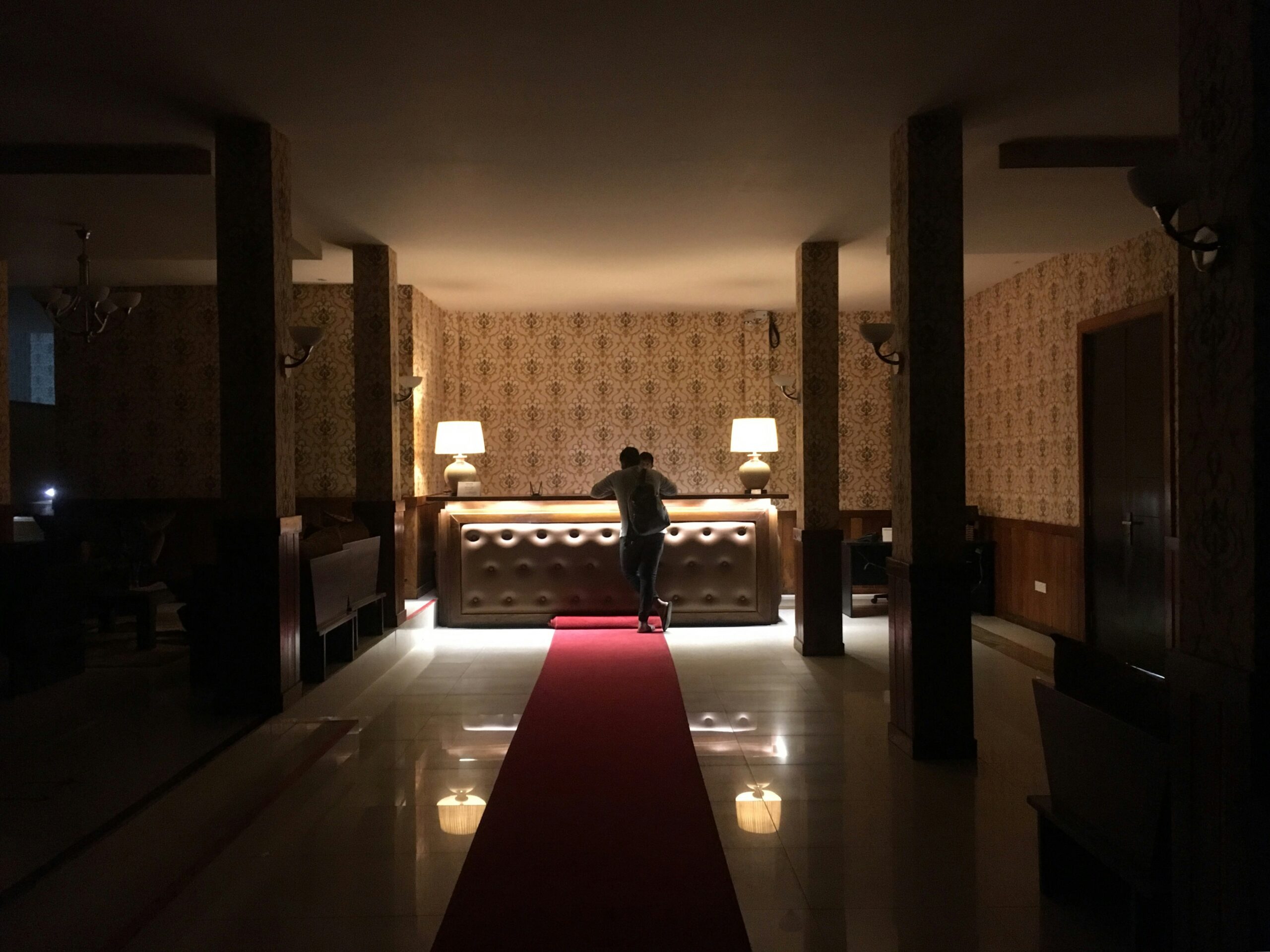 Concierge welcoming residents in a luxury condo lobby, representing personalized service and modern living.
