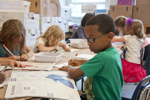 A class of children doing classwork at a private school